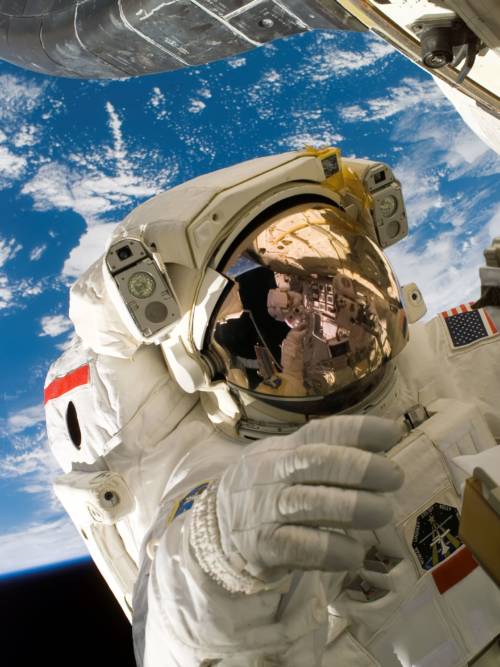 Astronaut in space wallpaper for mobiles and tablets