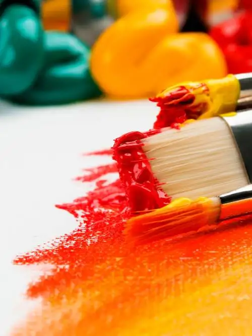 Paint brushes on white textile wallpaper