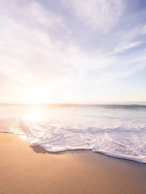 Waves crashing on beach wallpaper